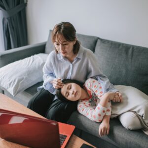 mom with sick daughter doing telehealth doctor call